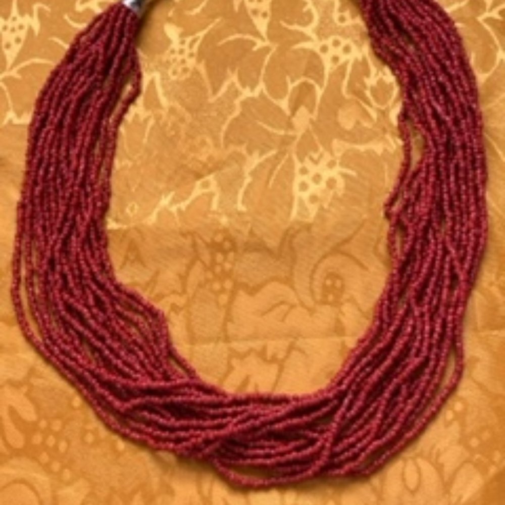 16 coral strands 18" long with 2" silver beads and lobster claw clasp